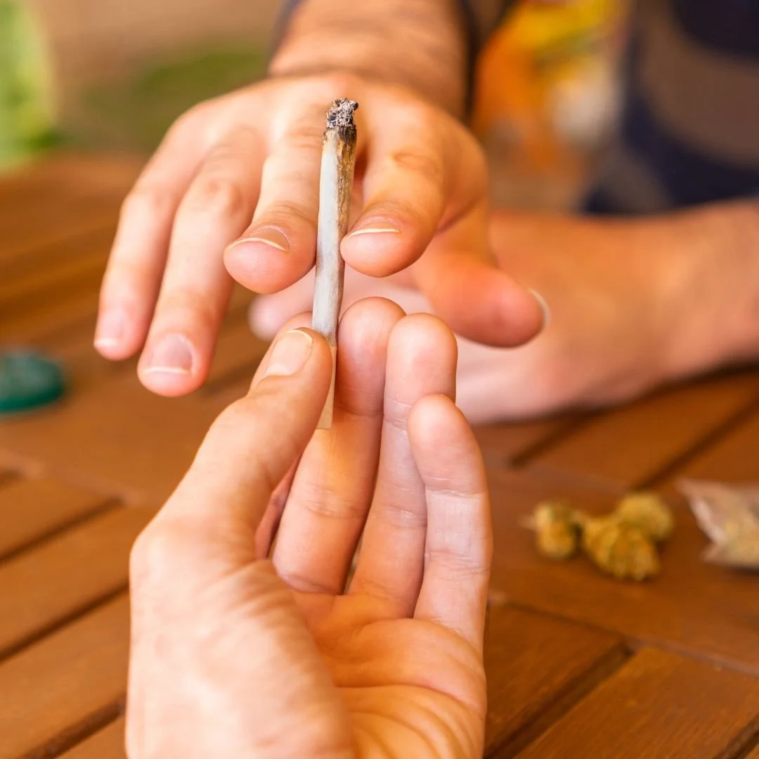 two people passing a joint on 420